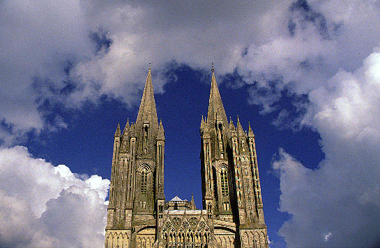 The slender, crocketed spires add verticality to what began as a Romanesque cathedral.